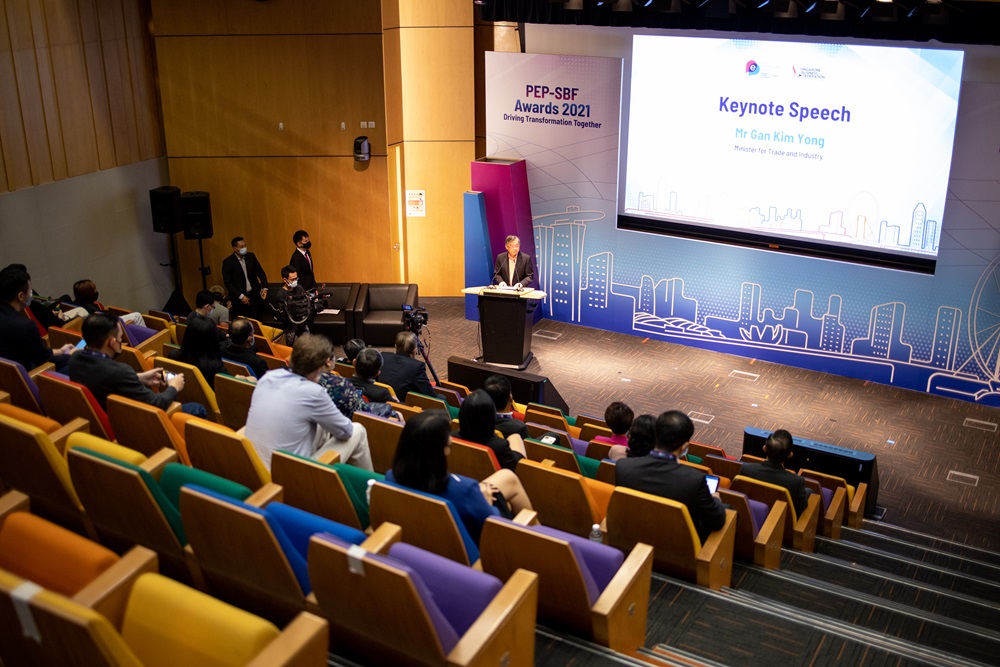 Minister delivers keynote at PEP‑SBF Awards 2021 in a colorful auditorium setting.